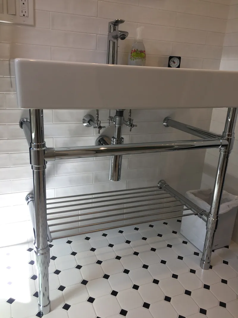 Sink and exposed pipework